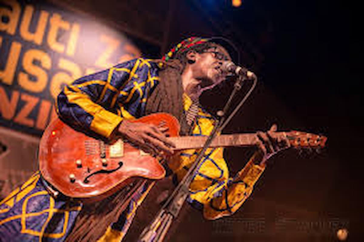 Cheikh Lô Music performing live with vibrant Senegalese instruments and lively audience